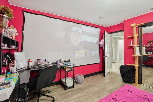 3336 Cherokee Ave, South Gate, CA 90280 - home office with wood finished floors, arched walkways, and baseboards