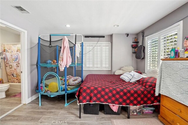 3336 Cherokee Ave, South Gate, CA 90280 - bedroom featuring wood finished floors, recessed lighting, connected bathroom, and baseboards