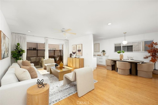 living room with light wood finished floors, ceiling fan, and recessed lighting