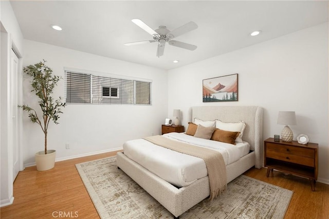 bedroom featuring light wood-style flooring, recessed lighting, baseboards, and a ceiling fan