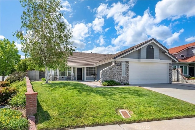 view of front of house featuring a garage, stone siding, concrete driveway, and a tile roof