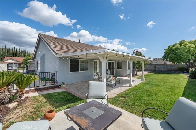 rear view of house with stucco siding, a patio area, and a tiled roof