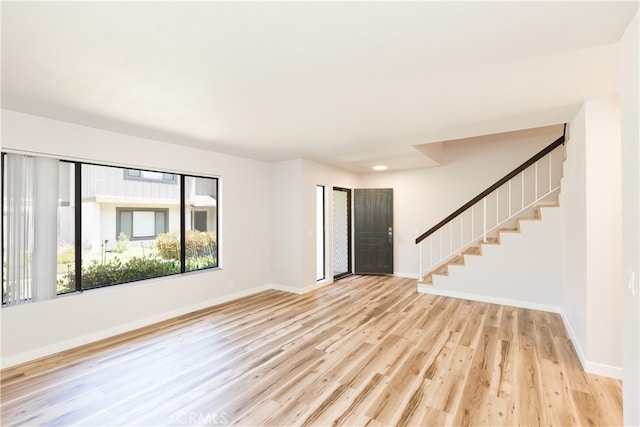 1485 W Cerritos Ave Unit 8, Anaheim, CA 92802 - unfurnished living room with stairway, light wood finished floors, baseboards, and recessed lighting