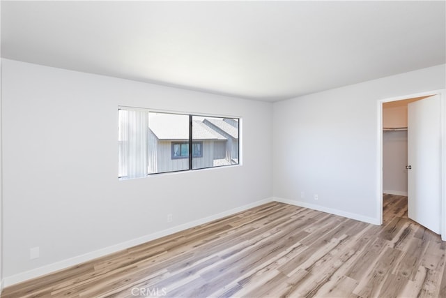 1485 W Cerritos Ave Unit 8, Anaheim, CA 92802 - unfurnished bedroom featuring light wood-type flooring, baseboards, a closet, and a spacious closet