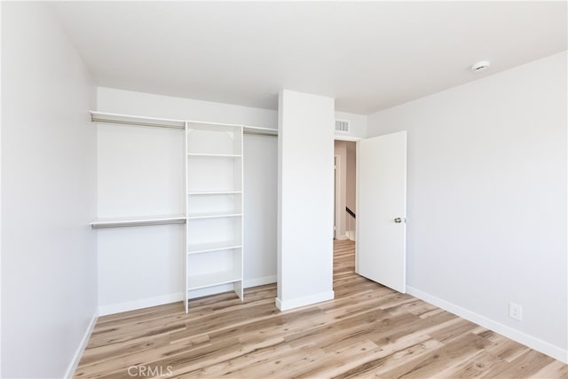 1485 W Cerritos Ave Unit 8, Anaheim, CA 92802 - unfurnished bedroom with wood finished floors, baseboards, and a closet