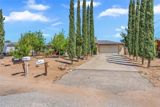 16230 Rodeo St, Hesperia, CA 92345 - view of property hidden behind natural elements with driveway and a chimney