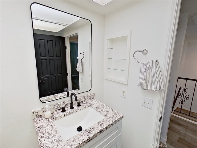 bathroom with vanity and wood finished floors