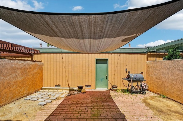 view of patio with fence and area for grilling