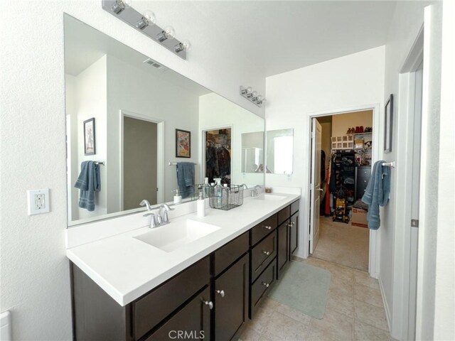 5485 San Roberto, San Diego, CA 92154 - bathroom featuring a spacious closet, double vanity, and tile patterned flooring