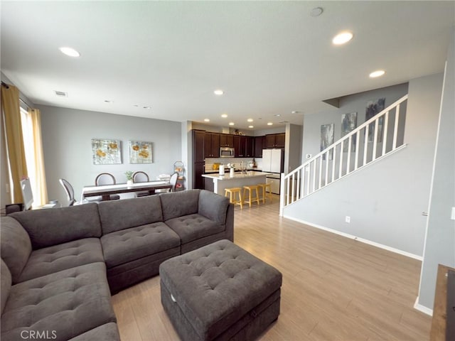 5485 San Roberto, San Diego, CA 92154 - living room featuring light wood-style flooring, recessed lighting, baseboards, and stairs