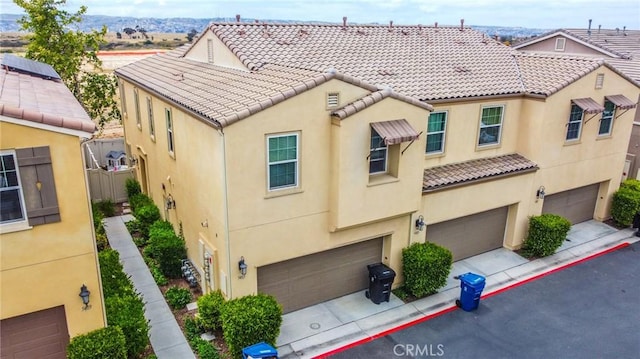5485 San Roberto, San Diego, CA 92154 - view of front of home featuring stucco siding, a garage, a tiled roof, and driveway