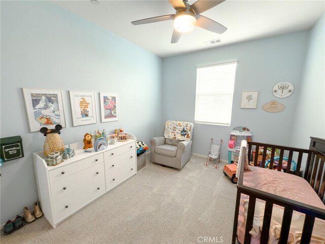 5485 San Roberto, San Diego, CA 92154 - bedroom with light carpet, a nursery area, and a ceiling fan