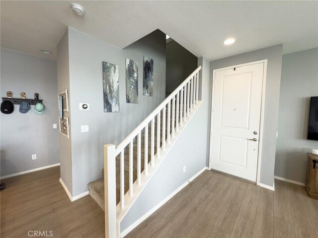 5485 San Roberto, San Diego, CA 92154 - stairs featuring wood finished floors, baseboards, and recessed lighting