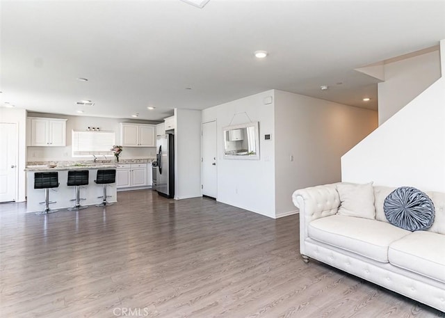 14205 Nicoles Way, Adelanto, CA 92301 - living area with dark wood finished floors, recessed lighting, and baseboards