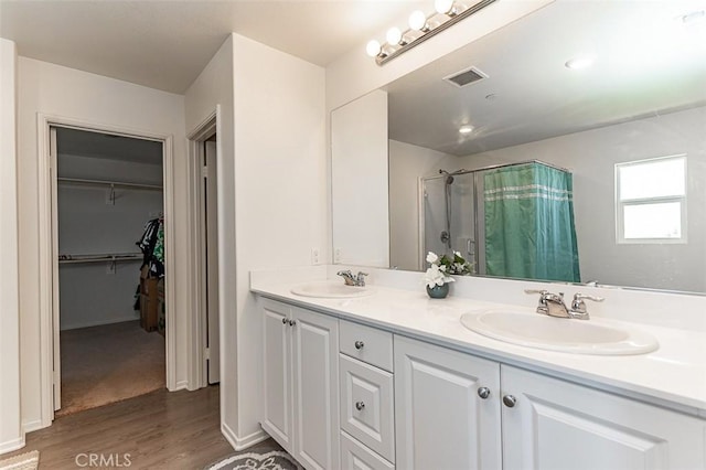 14205 Nicoles Way, Adelanto, CA 92301 - full bathroom featuring curtained shower, wood finished floors, double vanity, and a walk in closet