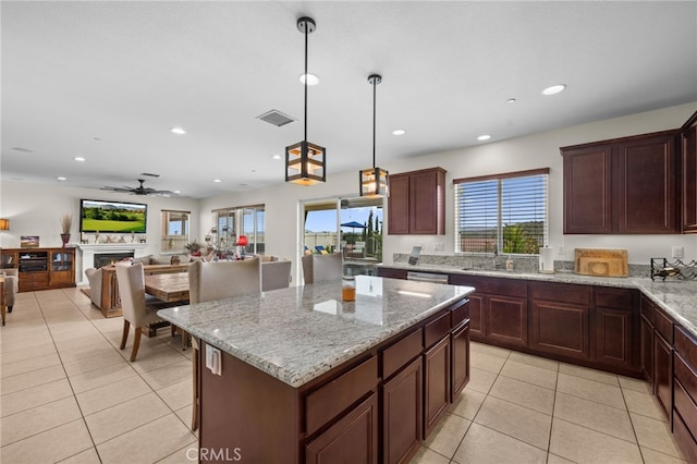 45936 Camino Rubi, Temecula, CA 92592 - kitchen with recessed lighting, light tile patterned flooring, a ceiling fan, a kitchen island, and light stone counters