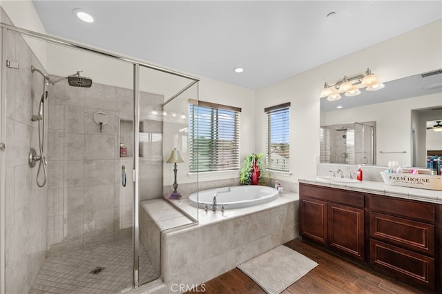 45936 Camino Rubi, Temecula, CA 92592 - bathroom featuring wood finished floors, a shower stall, a garden tub, vanity, and recessed lighting