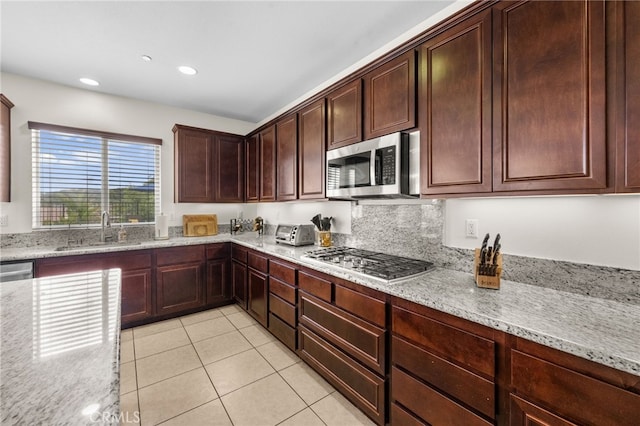 45936 Camino Rubi, Temecula, CA 92592 - kitchen with a sink, appliances with stainless steel finishes, light stone counters, light tile patterned flooring, and recessed lighting