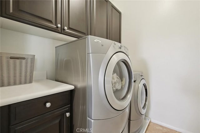 8519 E Kendra Loop, Orange, CA 92867 - laundry room with cabinet space, washing machine and clothes dryer, baseboards, and light tile patterned floors
