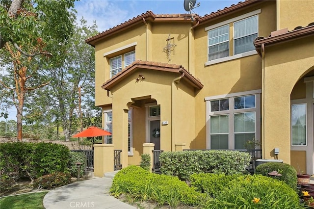 8519 E Kendra Loop, Orange, CA 92867 - property entrance with stucco siding, fence, and a tile roof