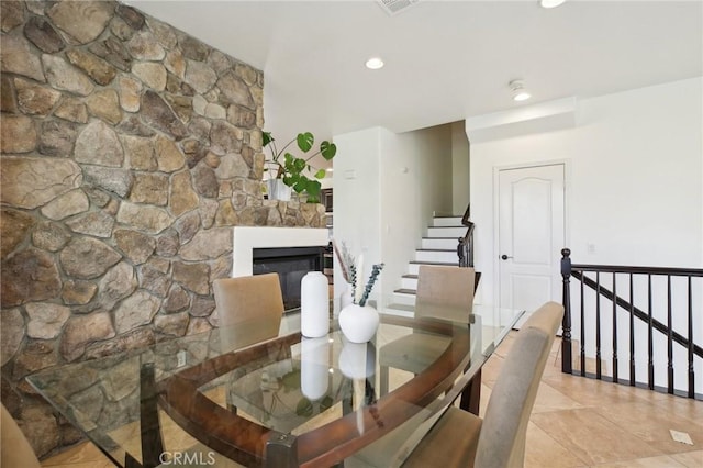 8519 E Kendra Loop, Orange, CA 92867 - dining area featuring light tile patterned floors, a glass covered fireplace, recessed lighting, and stairs