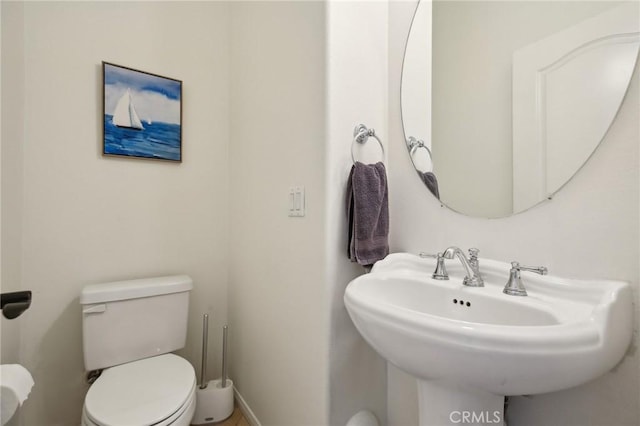 8519 E Kendra Loop, Orange, CA 92867 - half bathroom featuring toilet, a sink, and baseboards