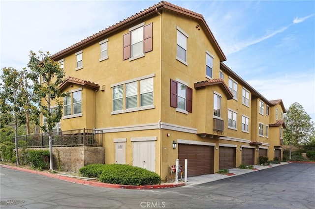 8519 E Kendra Loop, Orange, CA 92867 - view of building exterior with a garage and fence