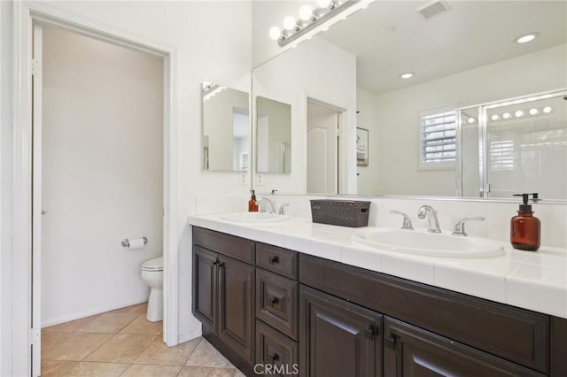 8519 E Kendra Loop, Orange, CA 92867 - full bathroom featuring toilet, a stall shower, double vanity, tile patterned flooring, and recessed lighting