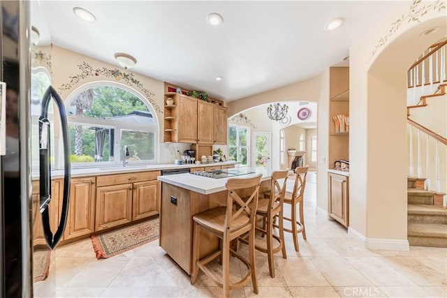 45975 Sandia Creek Dr, Temecula, CA 92590 - kitchen with black appliances, open shelves, a sink, light countertops, and arched walkways