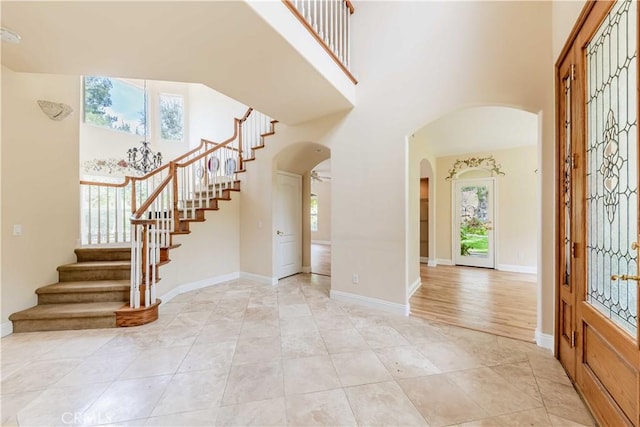 45975 Sandia Creek Dr, Temecula, CA 92590 - entrance foyer with arched walkways, healthy amount of natural light, stairway, and a high ceiling