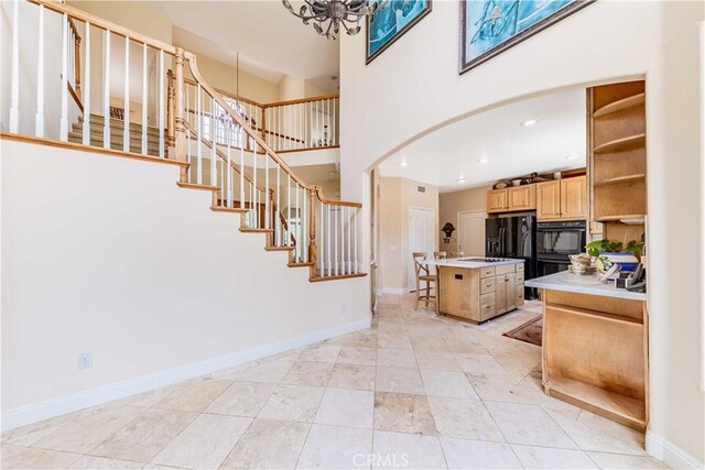 45975 Sandia Creek Dr, Temecula, CA 92590 - stairway featuring baseboards, a towering ceiling, a chandelier, and recessed lighting