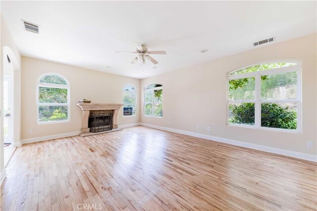 45975 Sandia Creek Dr, Temecula, CA 92590 - unfurnished living room with light wood-style flooring, a ceiling fan, healthy amount of natural light, and baseboards
