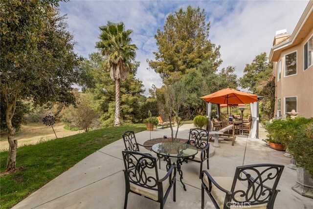 45975 Sandia Creek Dr, Temecula, CA 92590 - view of patio / terrace featuring outdoor dining space and view of wooded area