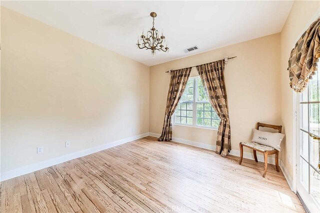 45975 Sandia Creek Dr, Temecula, CA 92590 - empty room featuring a chandelier, light wood-style flooring, and baseboards