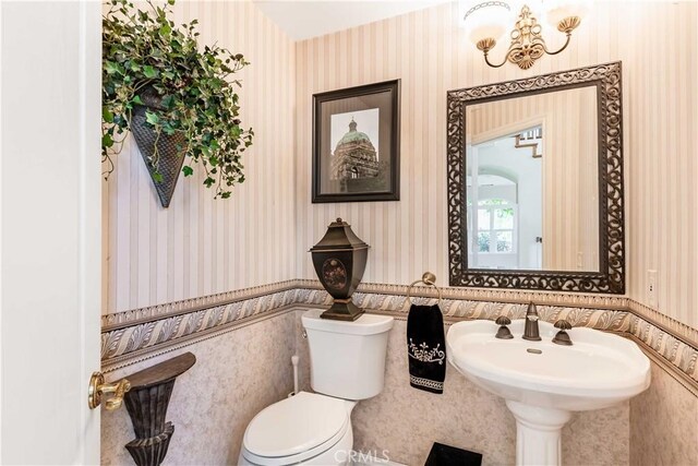 45975 Sandia Creek Dr, Temecula, CA 92590 - bathroom featuring wallpapered walls, toilet, and wainscoting