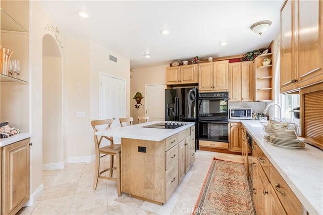 45975 Sandia Creek Dr, Temecula, CA 92590 - kitchen with black appliances, a sink, a kitchen breakfast bar, open shelves, and light brown cabinetry