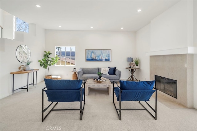 carpeted living area with recessed lighting and a tiled fireplace
