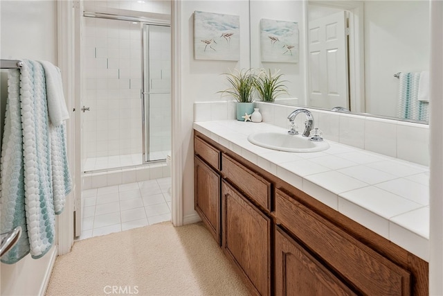 bathroom with a stall shower and vanity
