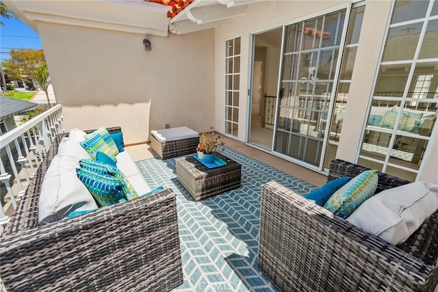 balcony featuring outdoor lounge area and a ceiling fan