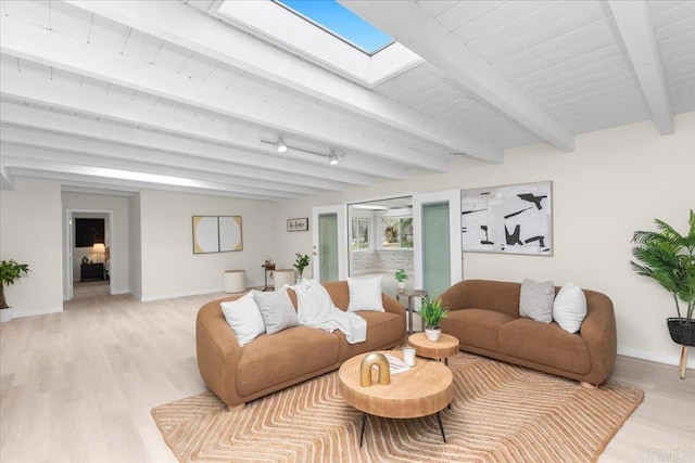 4566 Derrick Dr, San Diego, CA 92117 - living room featuring baseboards, light wood-style floors, beam ceiling, and a skylight