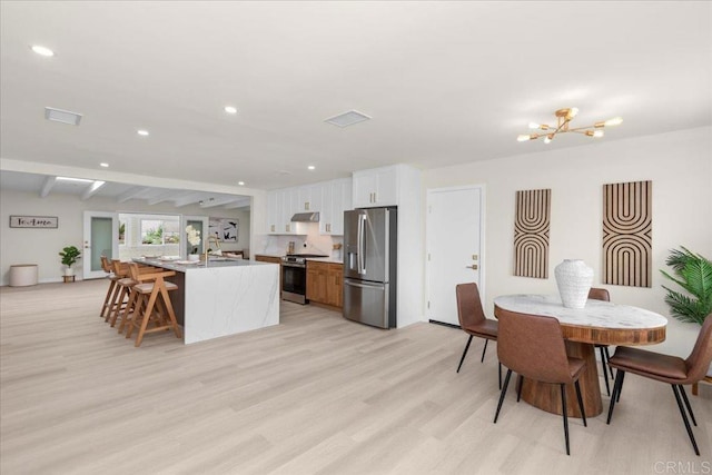 4566 Derrick Dr, San Diego, CA 92117 - dining space with light wood finished floors, recessed lighting, and a chandelier