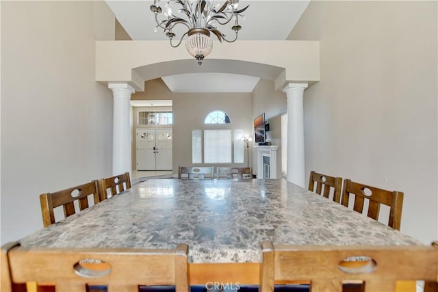 24062 Fuschia Ct, Murrieta, CA 92562 - dining space with arched walkways, a chandelier, and decorative columns