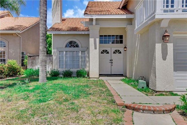 24062 Fuschia Ct, Murrieta, CA 92562 - property entrance with stucco siding, a tile roof, and a yard