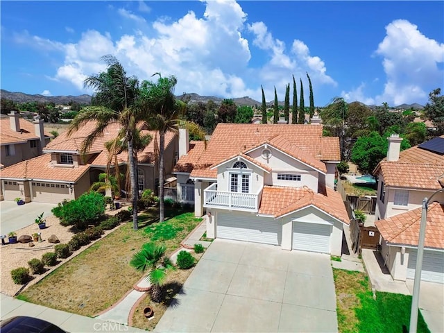24062 Fuschia Ct, Murrieta, CA 92562 - view of front of house with a tile roof, stucco siding, driveway, a balcony, and a mountain view