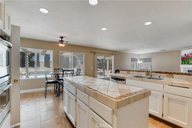 24062 Fuschia Ct, Murrieta, CA 92562 - kitchen with tile countertops, a sink, healthy amount of natural light, stainless steel appliances, and recessed lighting