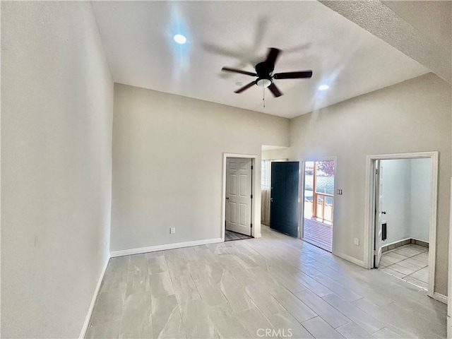 128130 E 1st St, Buttonwillow, CA 93206 - unfurnished bedroom with baseboards, recessed lighting, ensuite bathroom, and ceiling fan