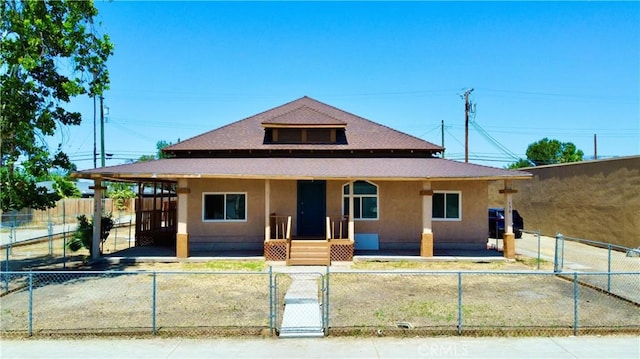 128130 E 1st St, Buttonwillow, CA 93206 - bungalow-style home with a gate, a porch, a fenced front yard, and stucco siding