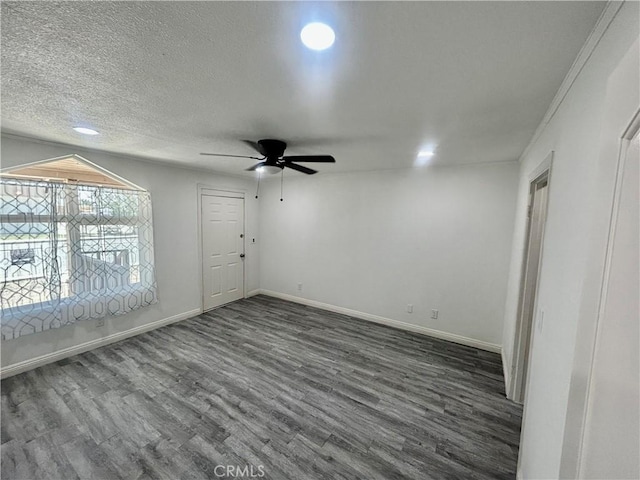 128130 E 1st St, Buttonwillow, CA 93206 - spare room featuring dark wood-style flooring, ceiling fan, recessed lighting, baseboards, and a textured ceiling