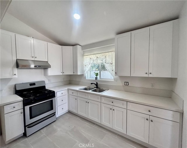 128130 E 1st St, Buttonwillow, CA 93206 - kitchen featuring gas range, under cabinet range hood, a sink, vaulted ceiling, and white cabinets