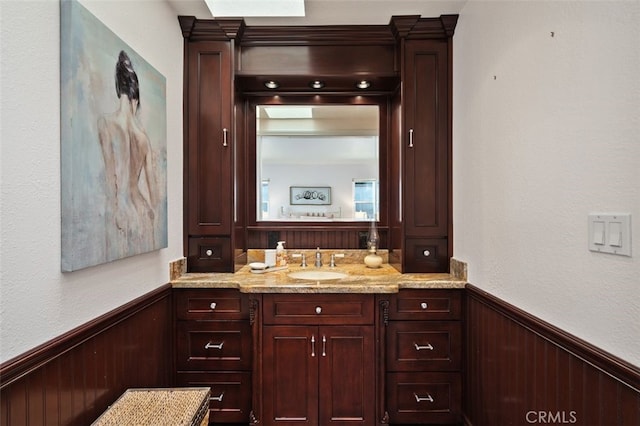 566 Elkhorn Dr, Duarte, CA 91010 - bathroom featuring wainscoting, wood walls, and vanity